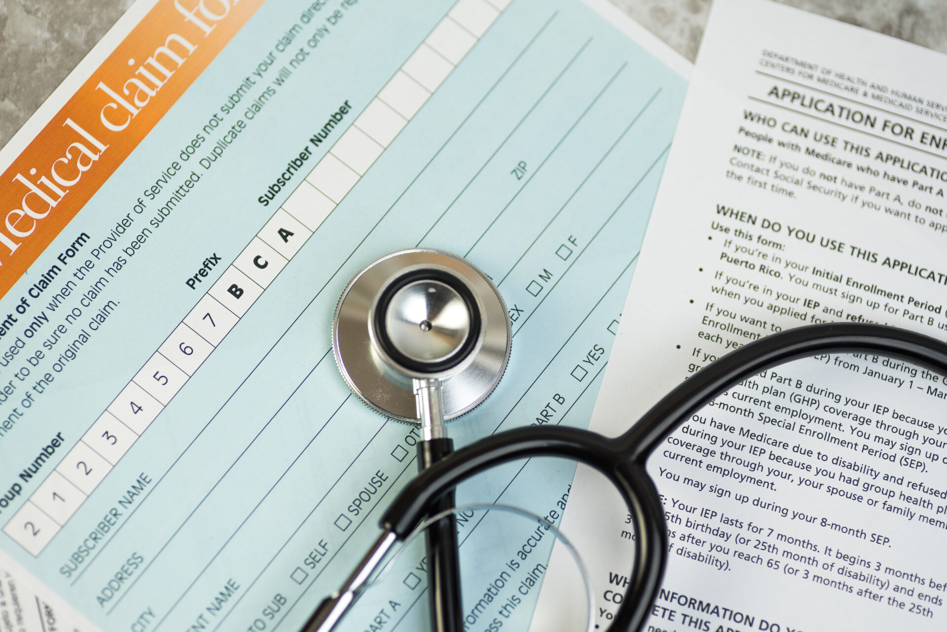 health care concept. medicare changes. insurance claim forms and stethoscope